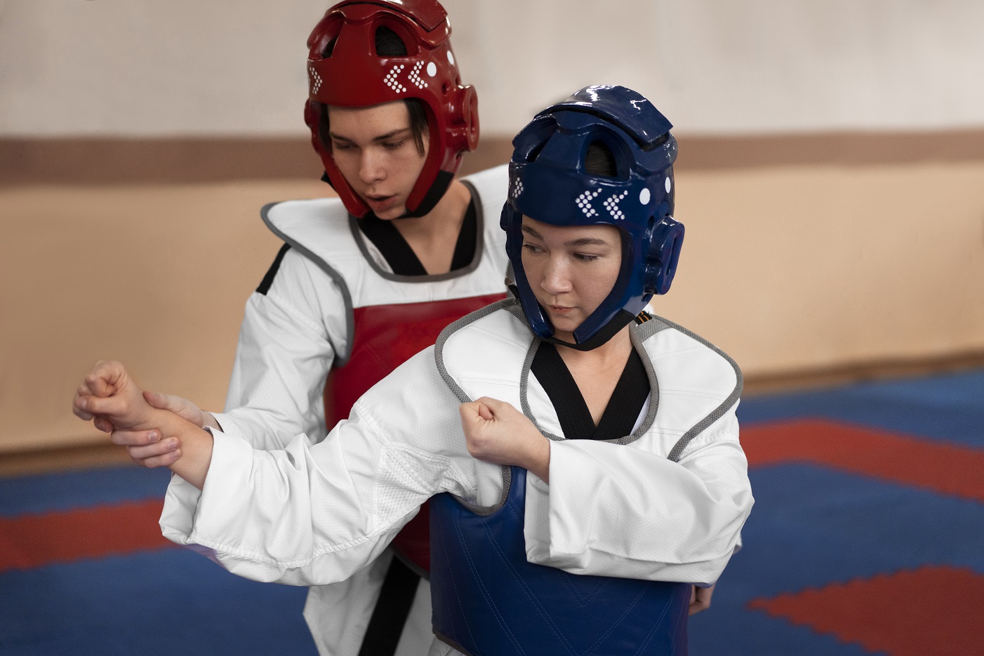 people-practicing-taekwondo-gymnasium